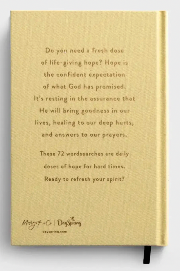 Book with inspirational text on a beige background