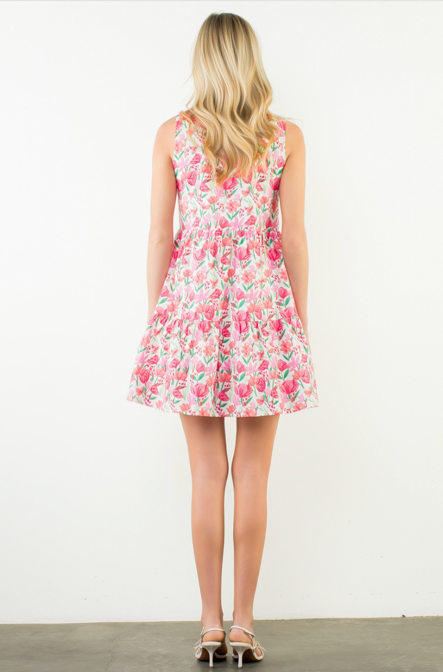 Woman wearing a floral dress on a white background