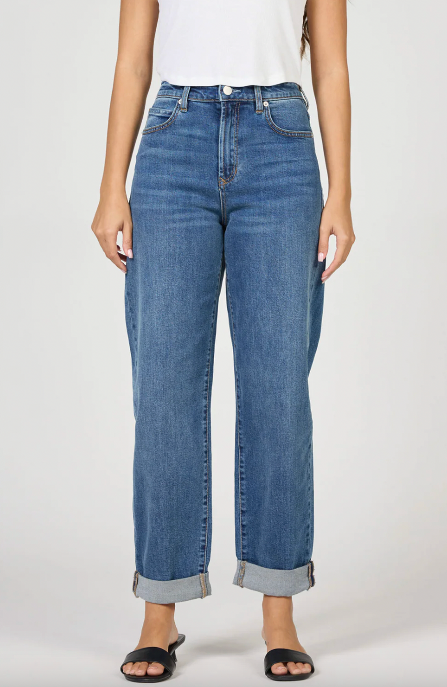 Person wearing blue jeans on a white background