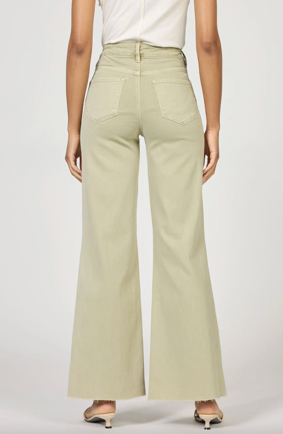 pastel green wide legged denim pants on model with white background