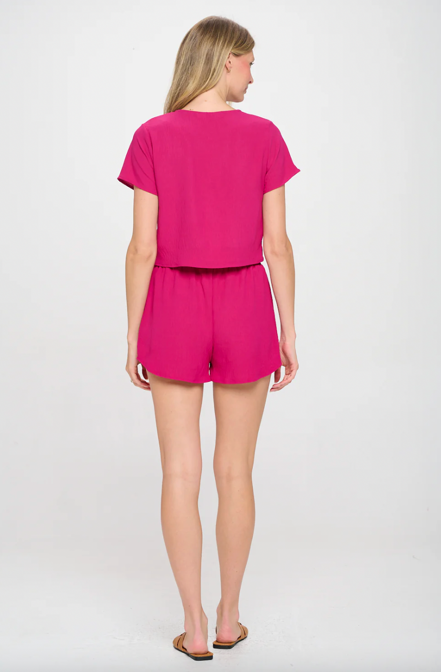 Woman wearing a pink outfit on a white background