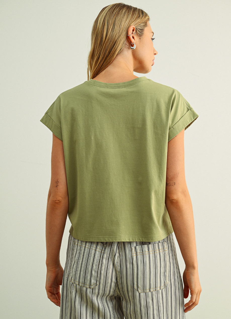 Person wearing a green t-shirt and striped pants on a plain background