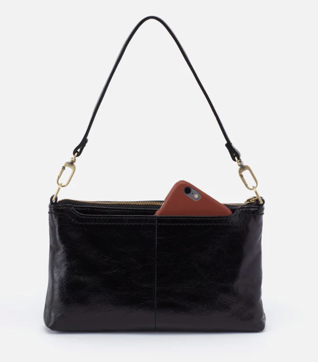 Black leather handbag with a brown phone case on a white background