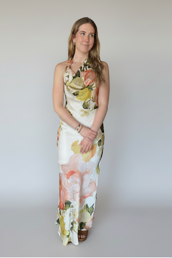 Woman wearing a floral dress on a white background. halter neck formal dress