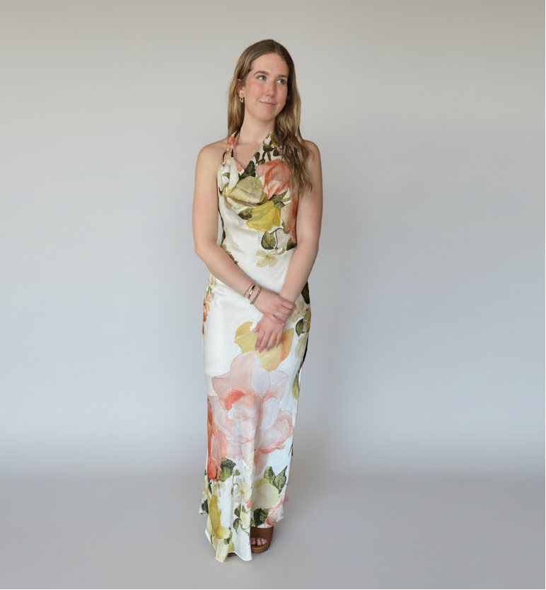 Woman wearing a floral dress on a white background. halter neck formal dress