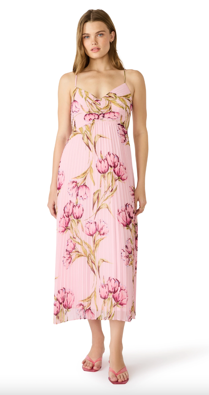 Woman wearing a pink floral dress on a white background