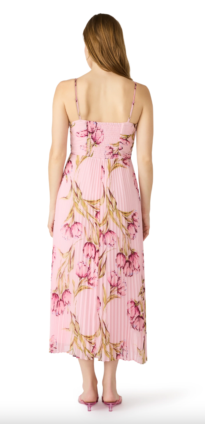 Woman wearing a pink floral dress on a white background