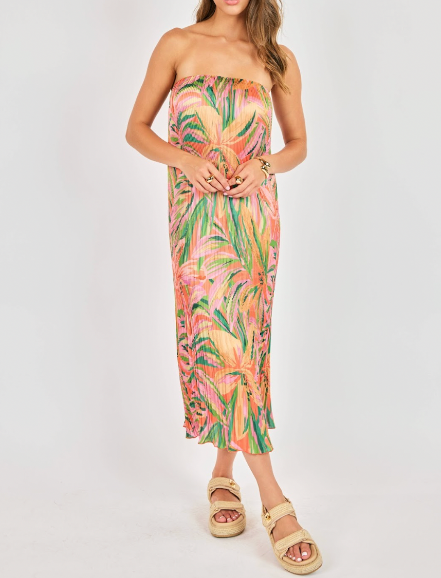 Woman wearing a strapless floral dress on a white background