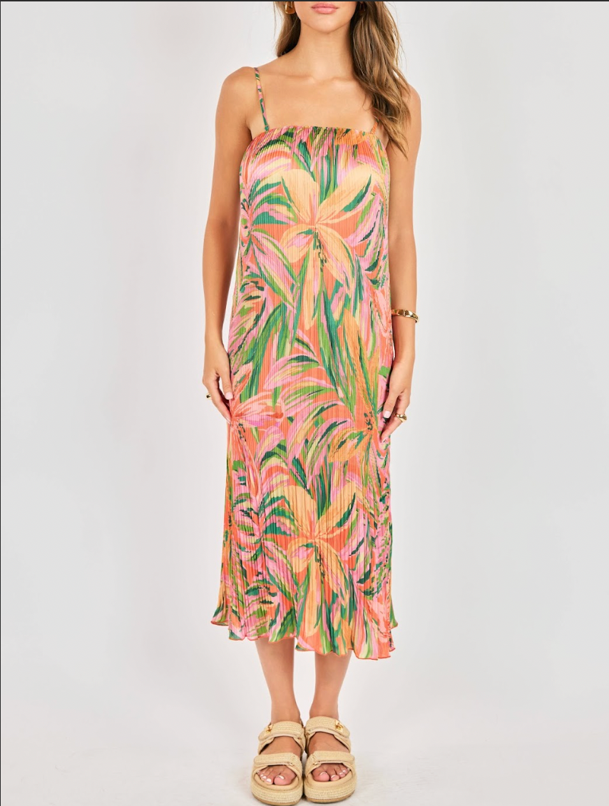 Woman wearing a colorful floral dress on a white background