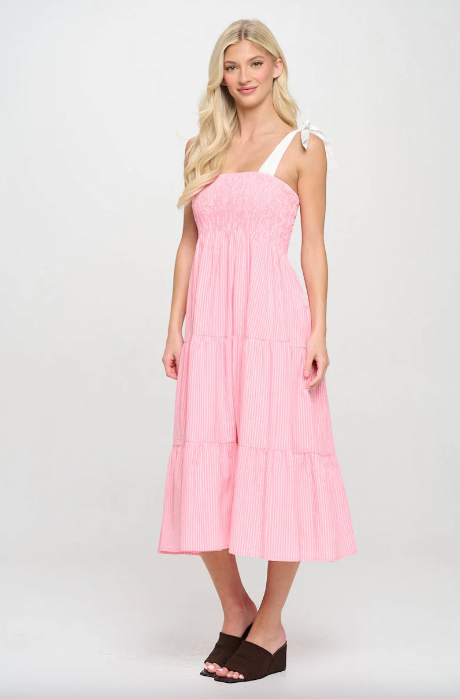 Woman wearing a pink dress on a white background