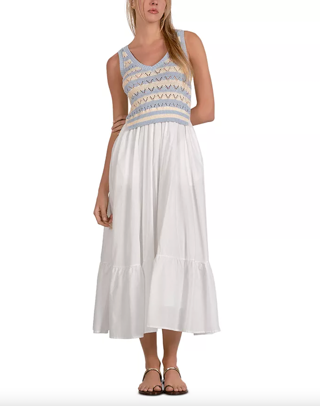 Woman wearing a white dress with a patterned top on a white background