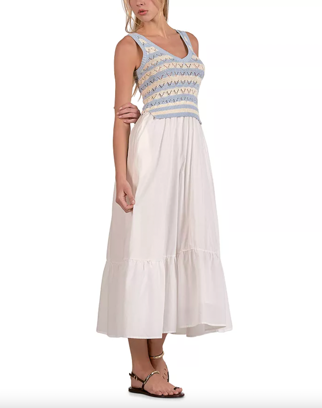 Woman wearing a white dress with blue and yellow patterned top on a white background