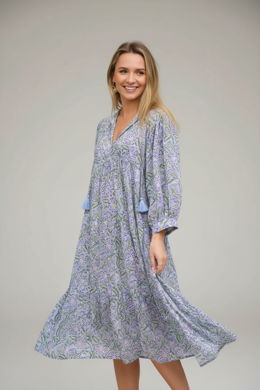 Woman wearing a floral dress standing outdoors with blurred background