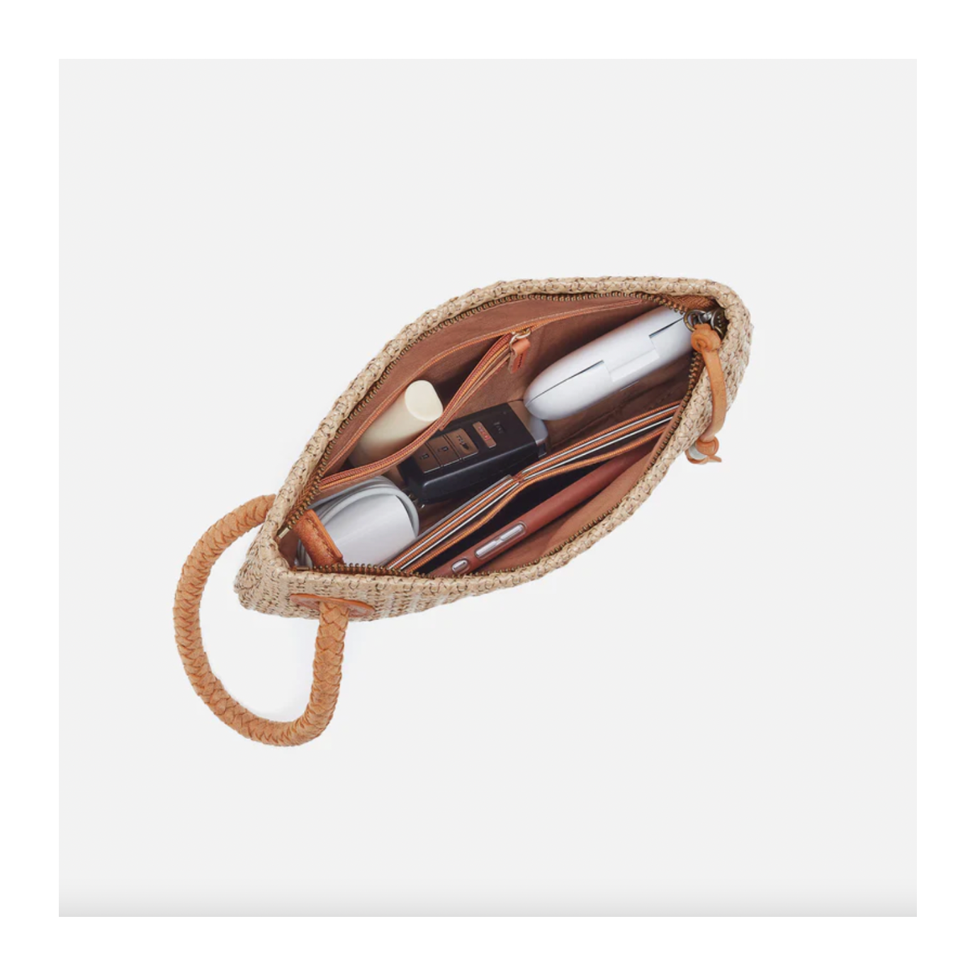 Open woven pouch with cosmetic items on a white background
