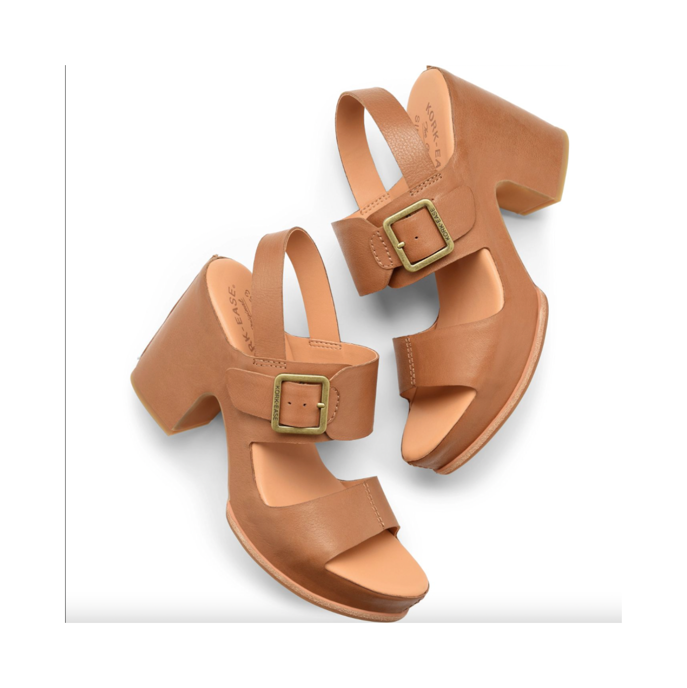 Pair of tan high-heeled sandals with gold buckles on a white background