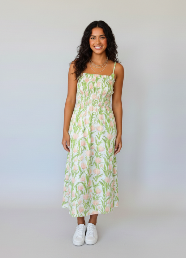 Woman wearing a floral dress against a plain background