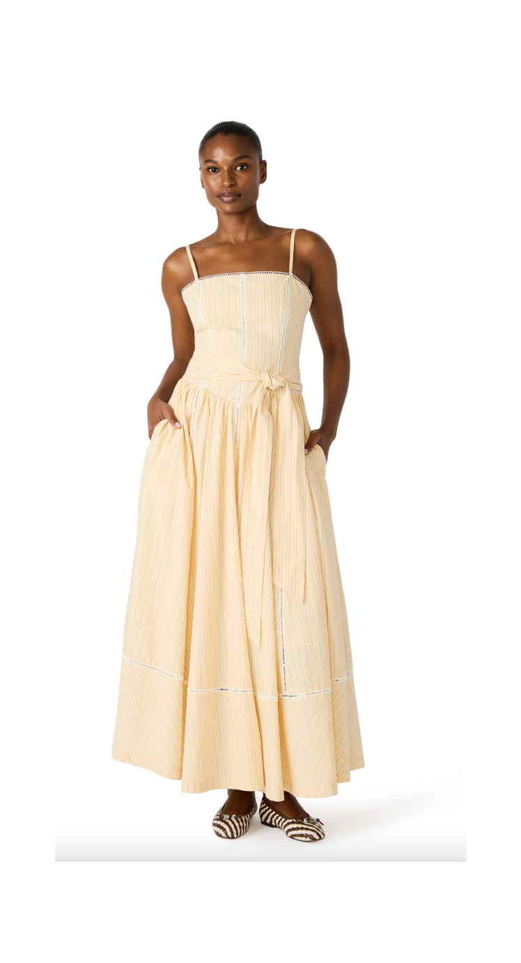 Woman wearing a beige strapless dress on a white background