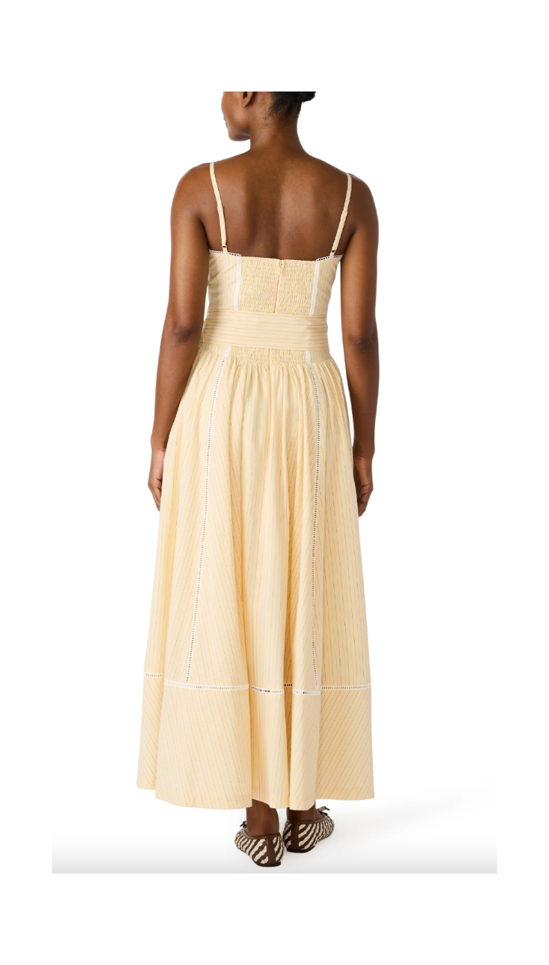 Woman wearing a beige dress on a white background