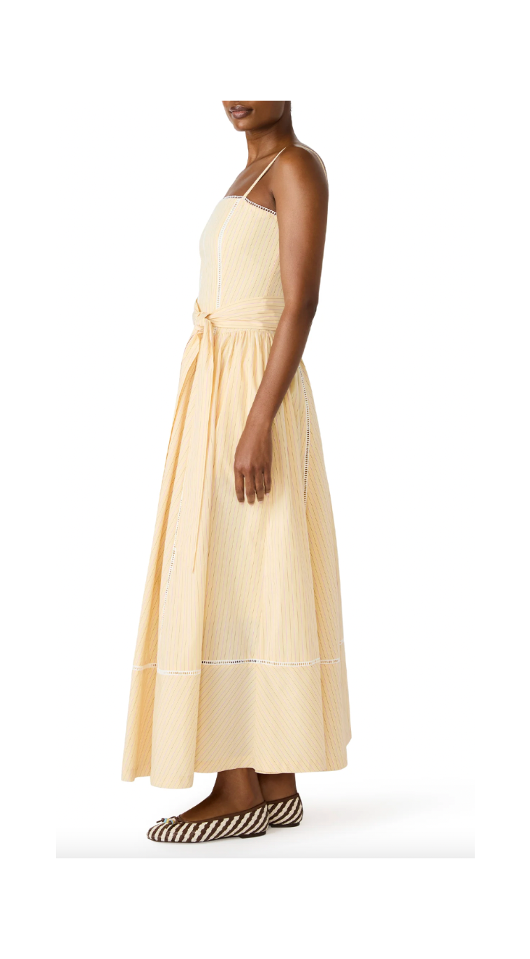 Woman wearing a beige dress with a white background