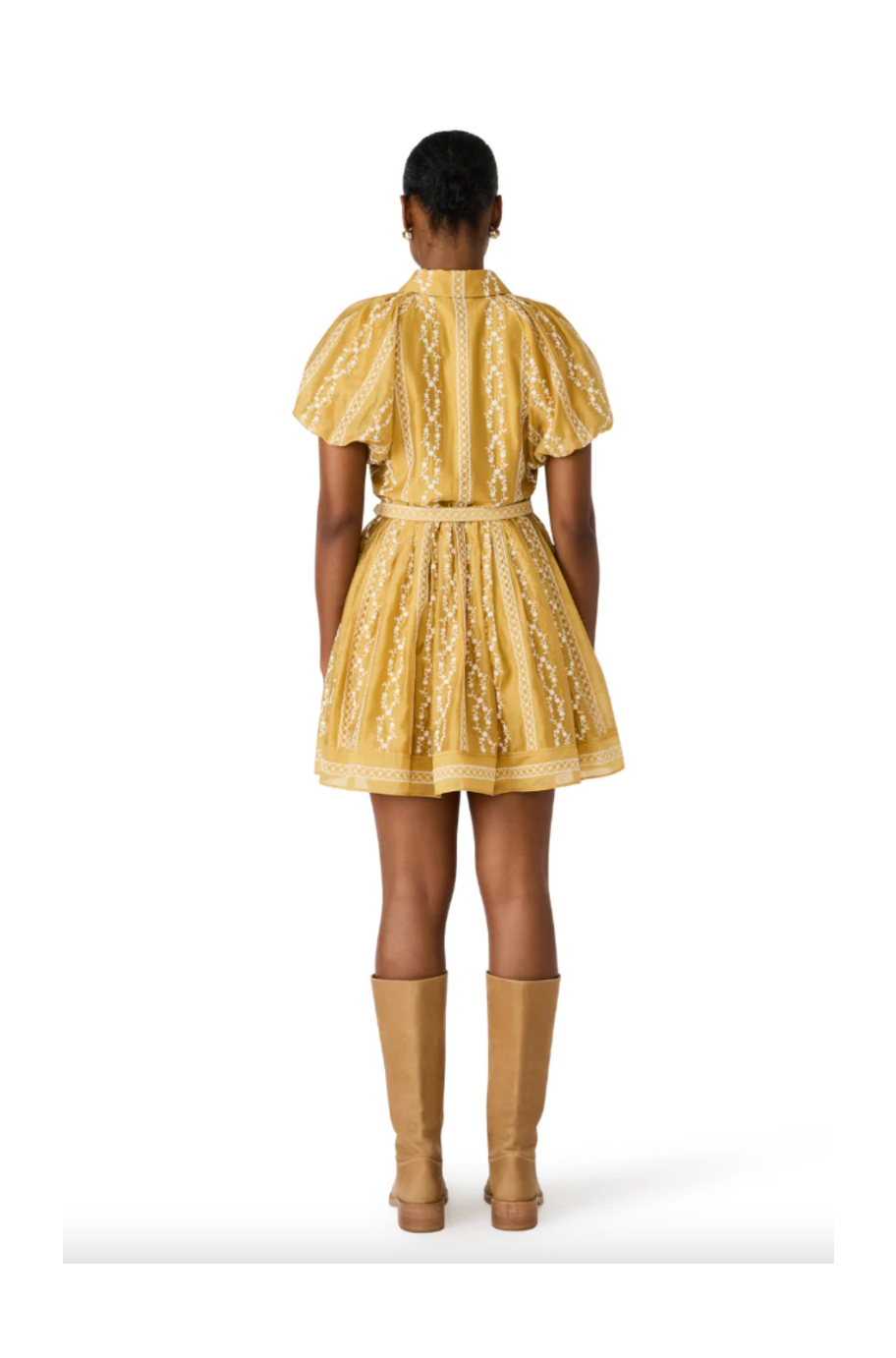 Person wearing a yellow dress with a white background