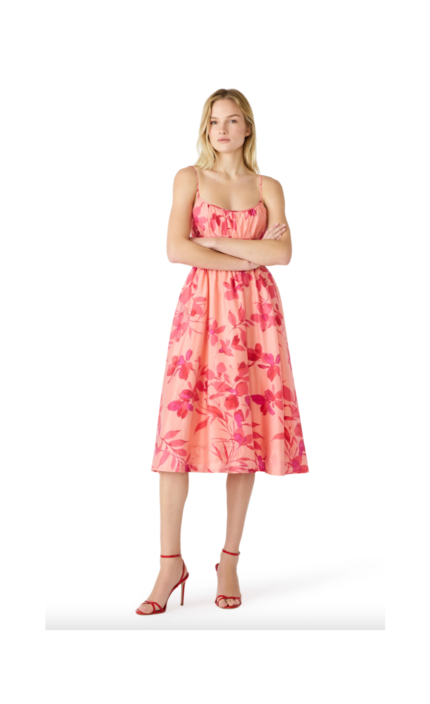 Woman wearing a pink floral dress on a white background