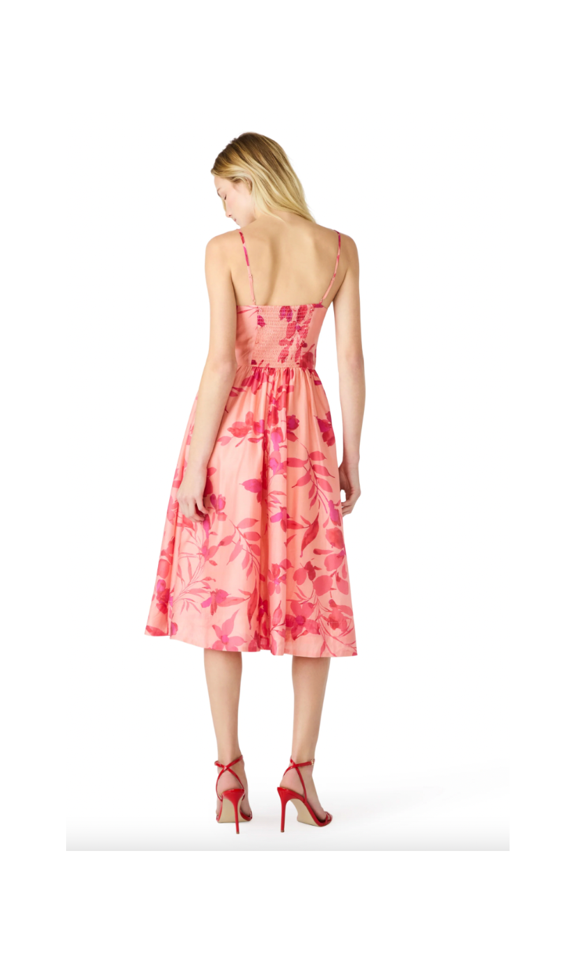 Woman wearing a pink floral dress on a white background