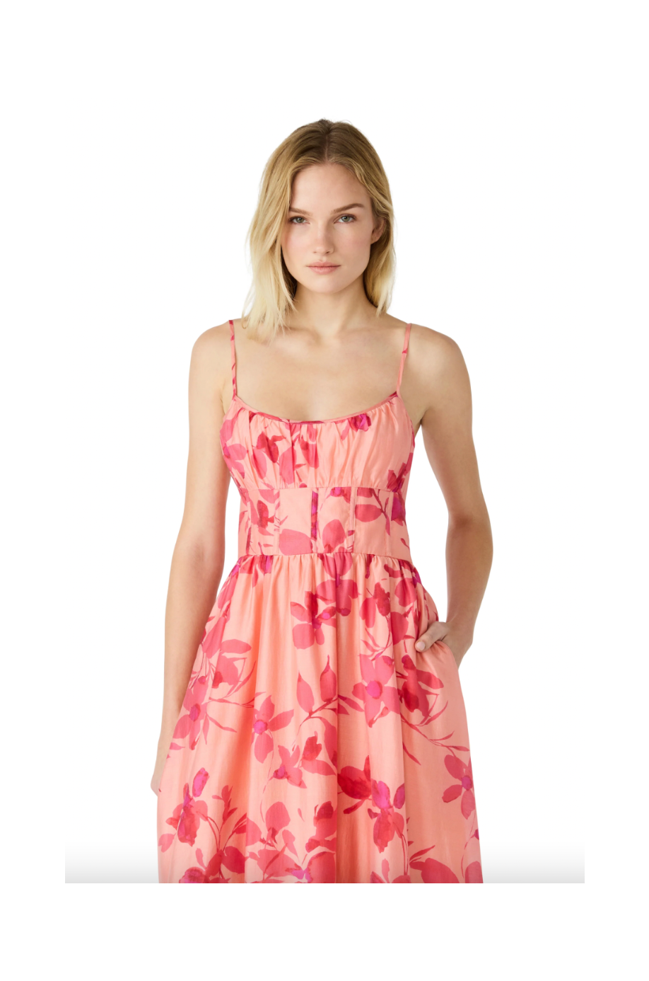 Woman wearing a pink floral dress on a white background