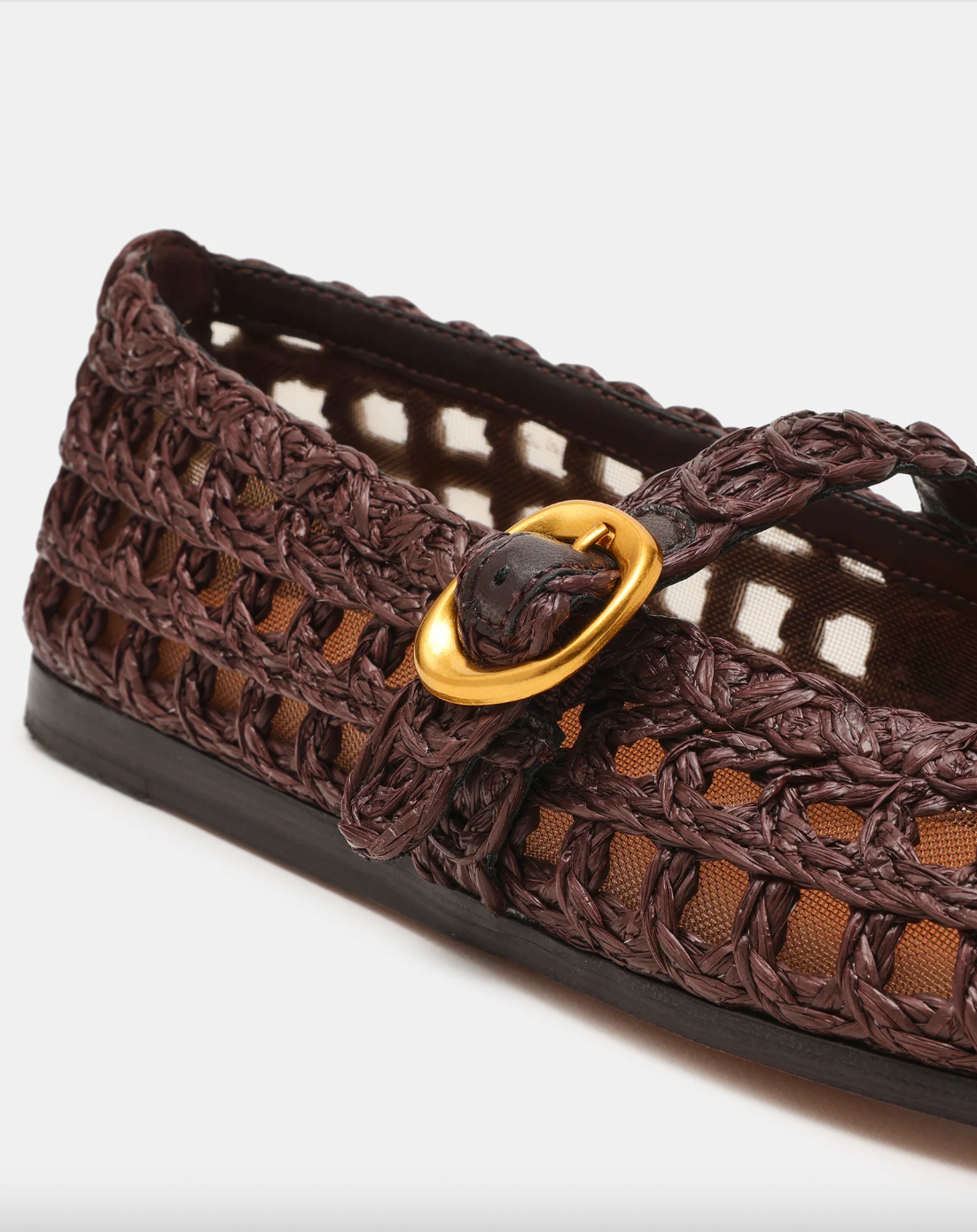 Brown woven shoe with a gold buckle on a white background