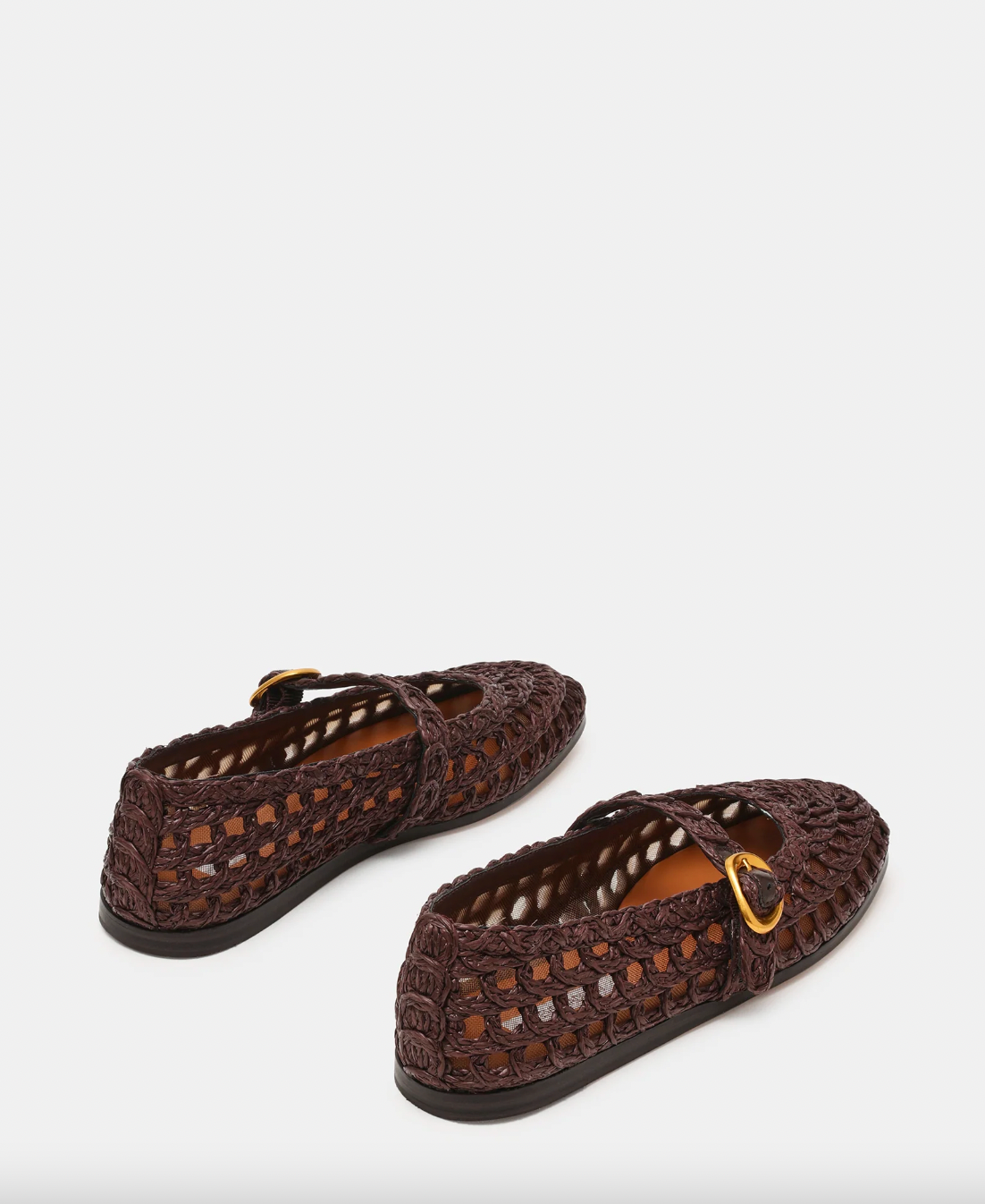 Pair of brown crochet shoes with gold accents on a white background