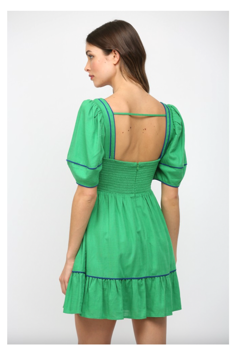 Green dress with open back on a white background