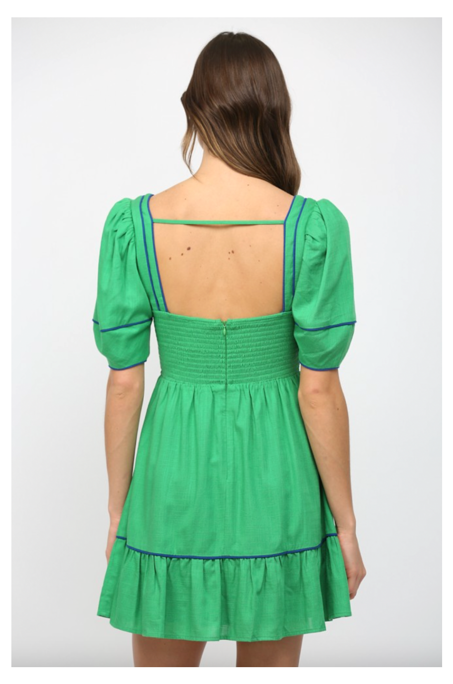 Green dress with open back on a white background