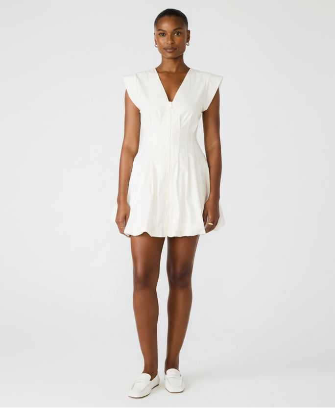 Woman wearing a white dress on a white background