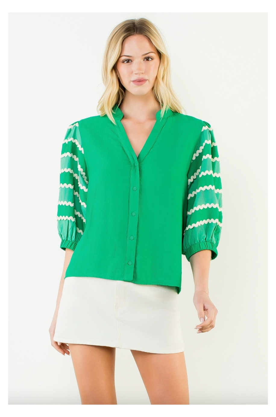 Woman wearing a green blouse with white stripes on a white background
