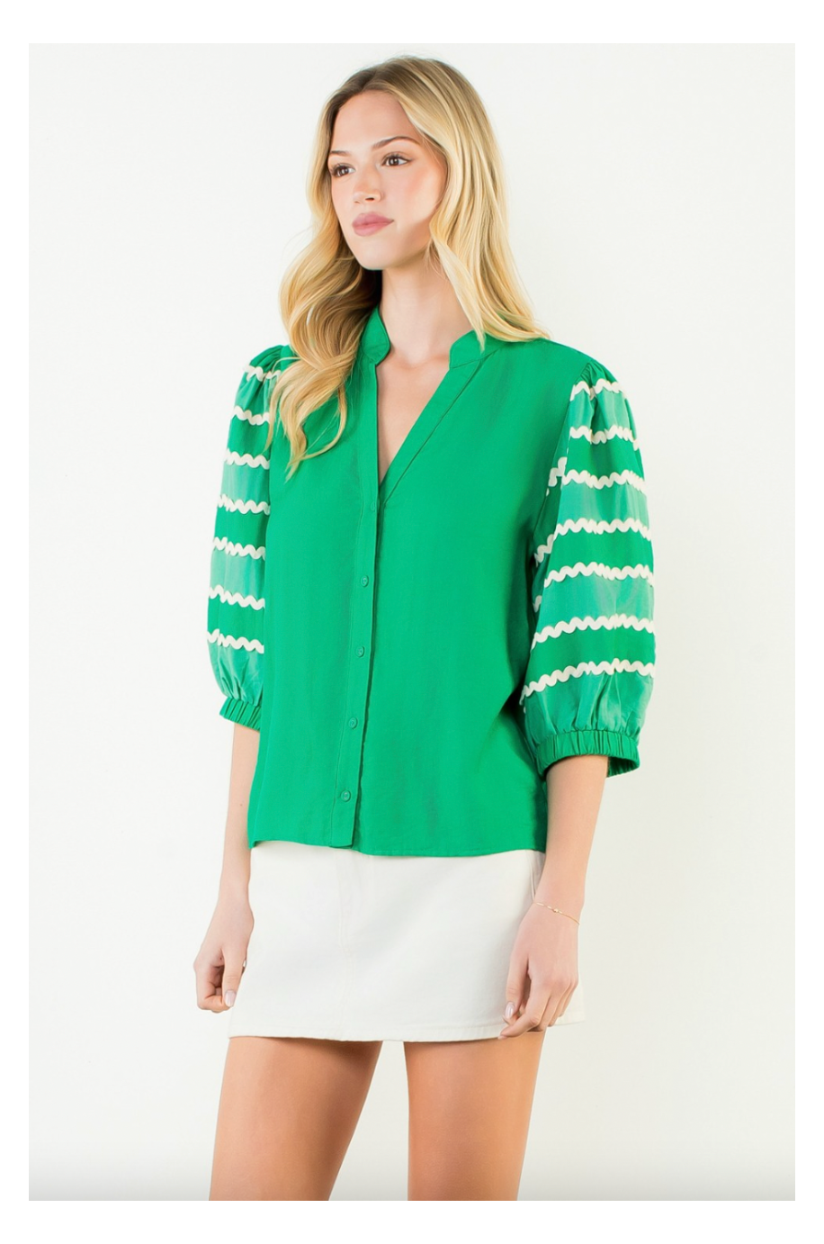 Woman wearing a green blouse with white stripes on a white background