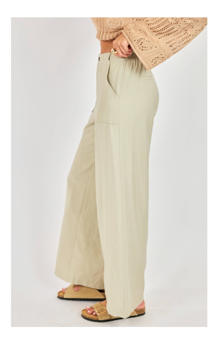 Beige wide-leg pants worn by a person on a white background