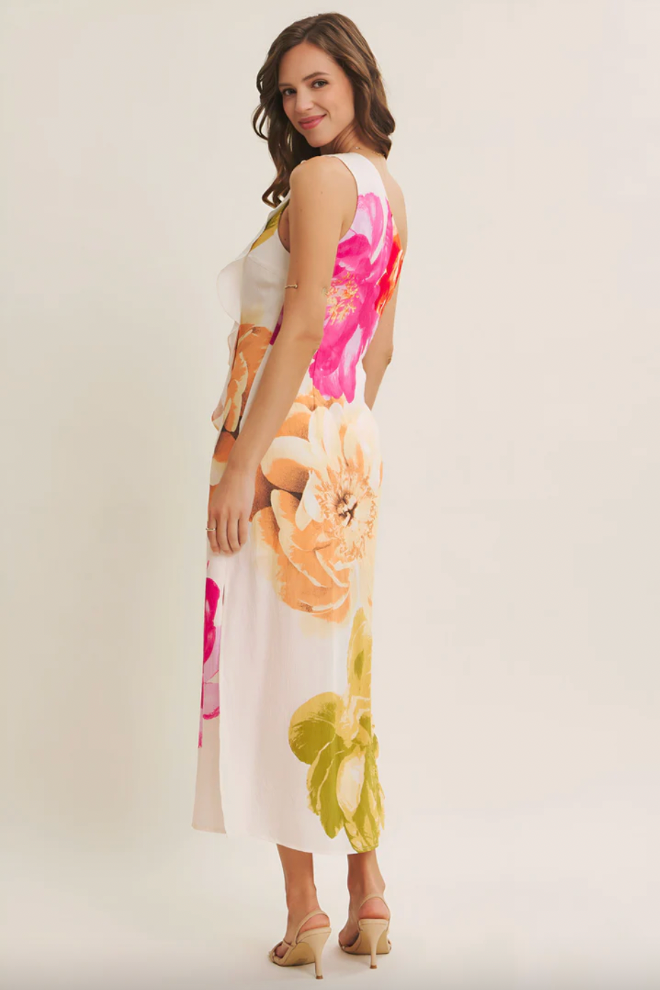 Woman wearing a floral dress on a plain background