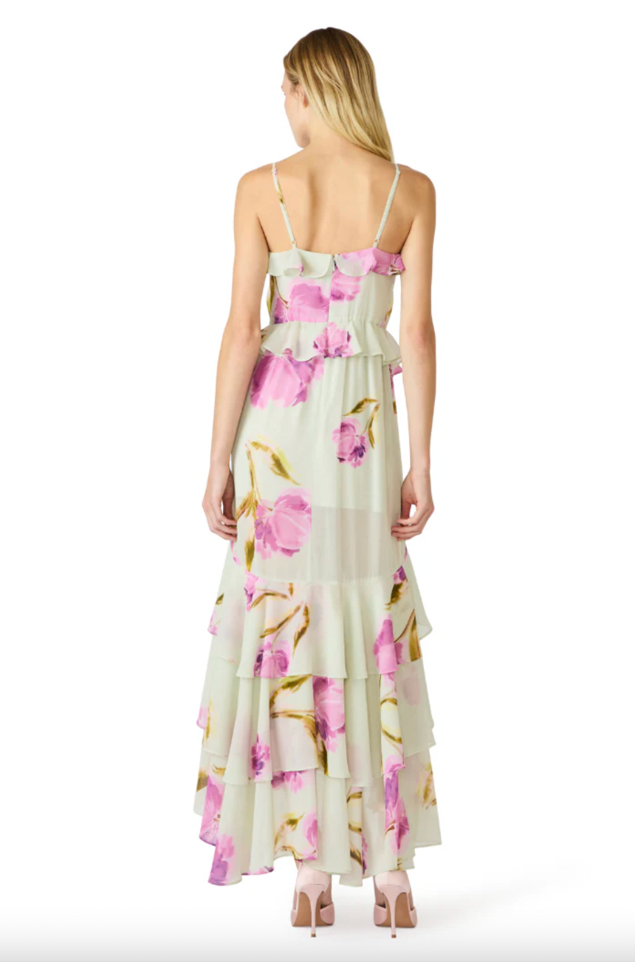 Woman wearing a floral dress with pink and yellow flowers on a white background