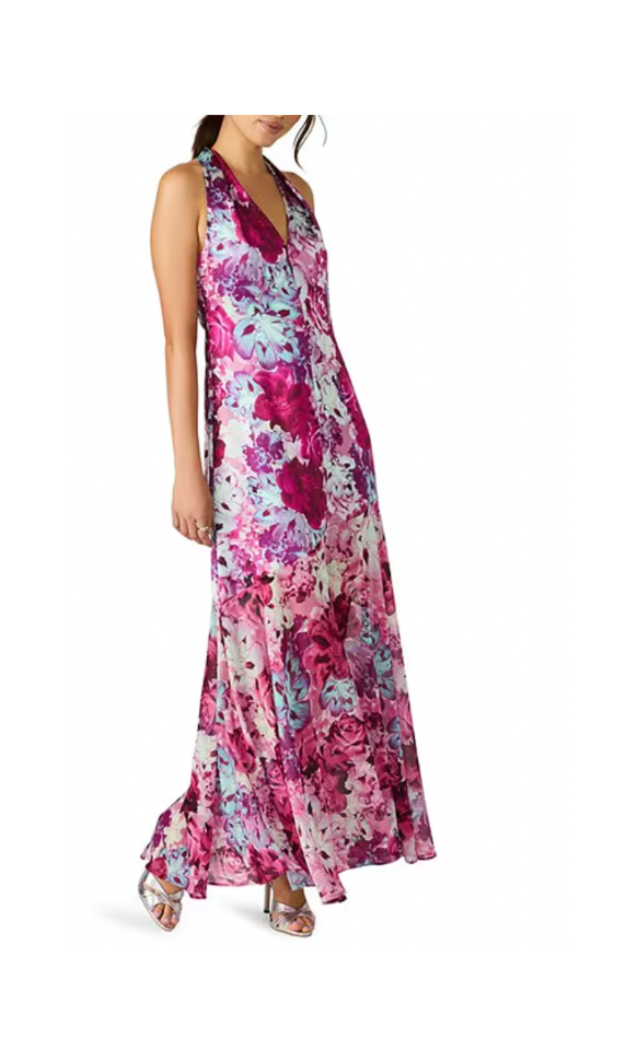 Woman wearing a floral maxi dress on a white background