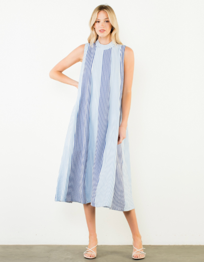 Woman wearing a blue and white striped dress on a white background