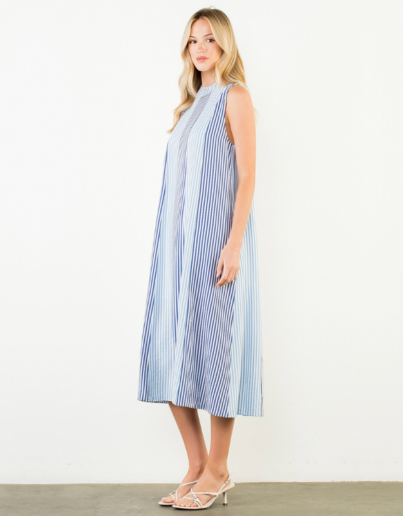 Woman wearing a blue and white striped dress on a white background