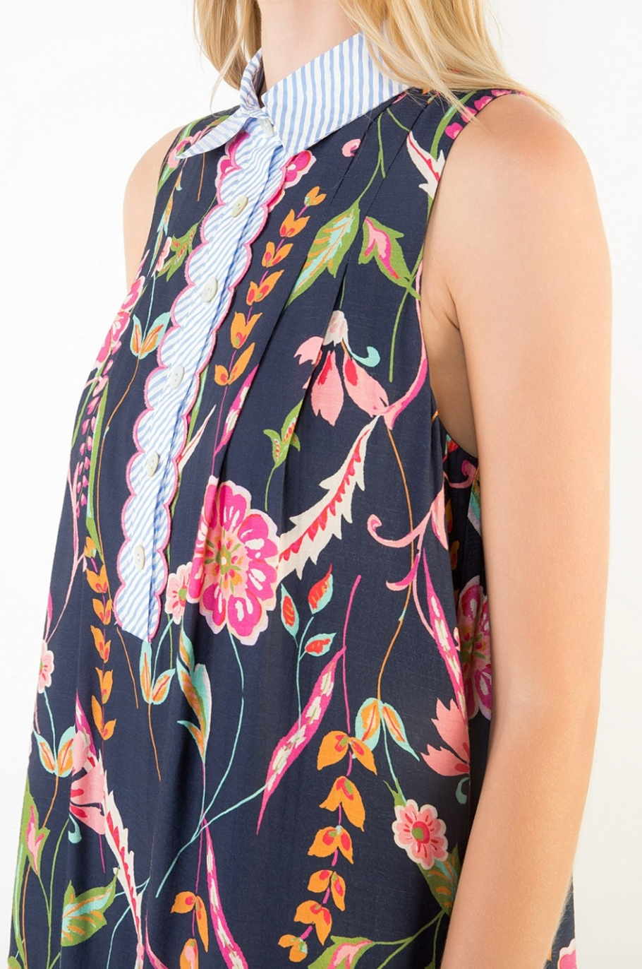 Woman wearing a sleeveless dress with a floral pattern on a white background
