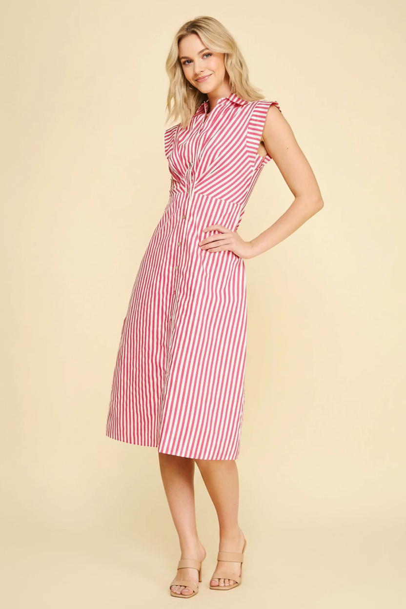Woman wearing a red and white striped dress against a beige background