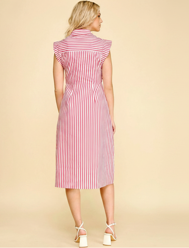 Woman wearing a red and white striped dress on a beige background