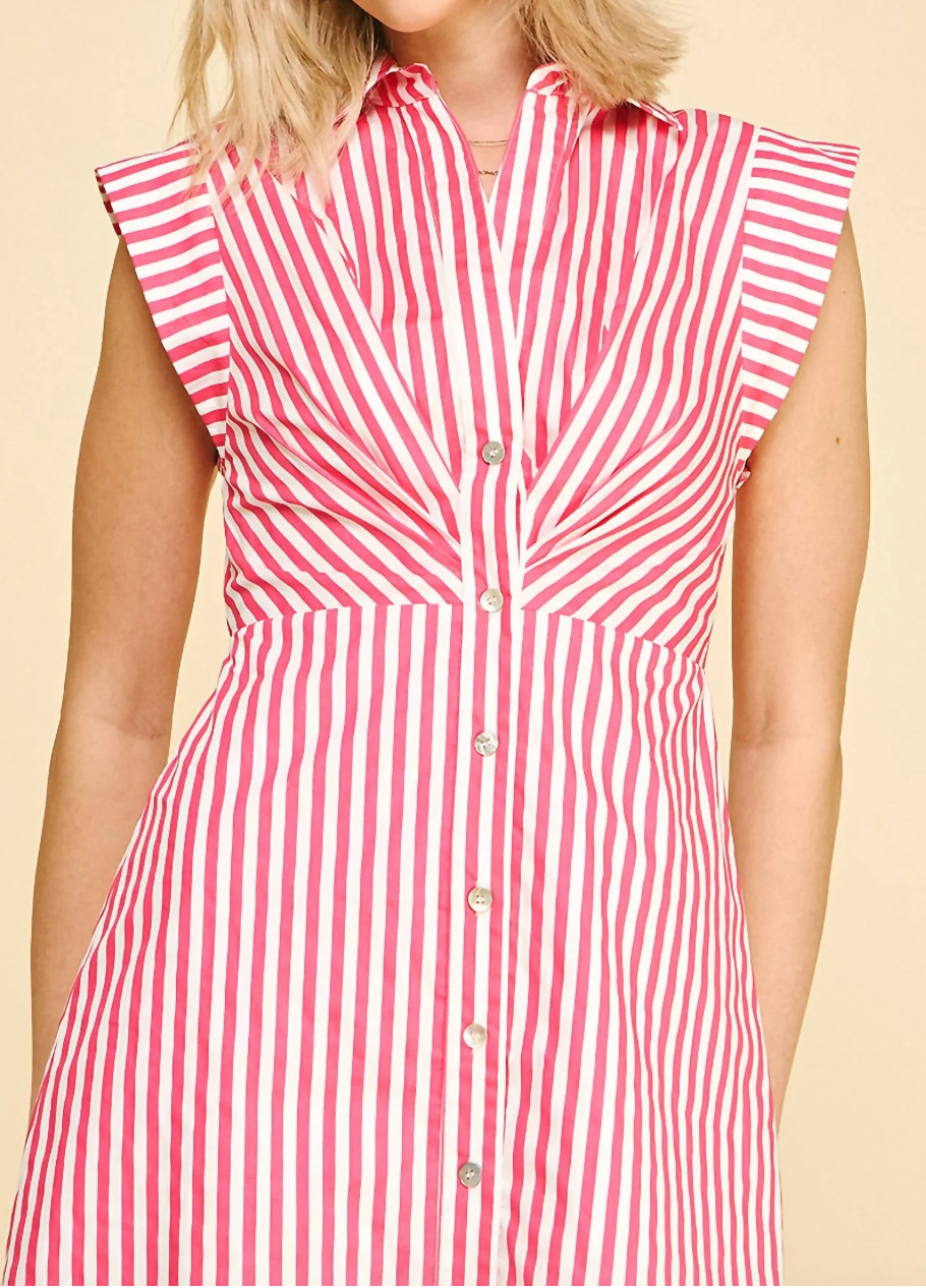 Woman wearing a red and white striped dress on a beige background