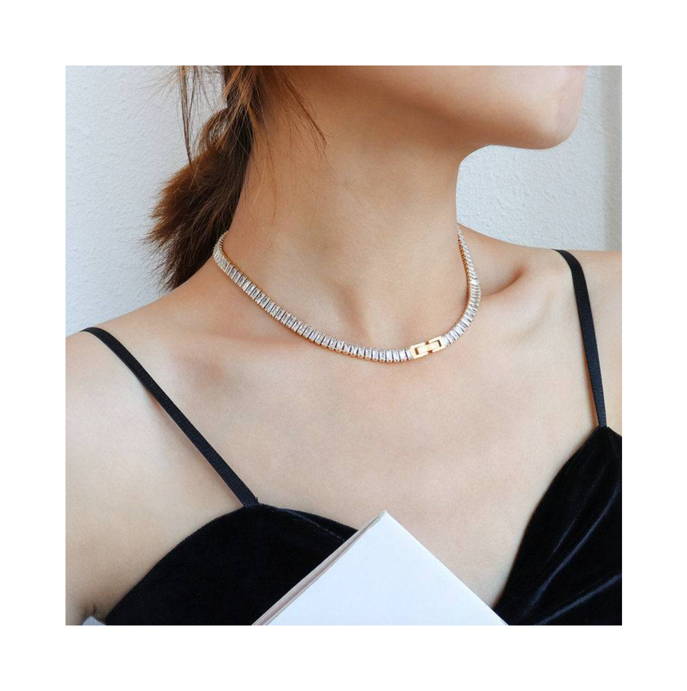 Necklace worn by a person with a plain background