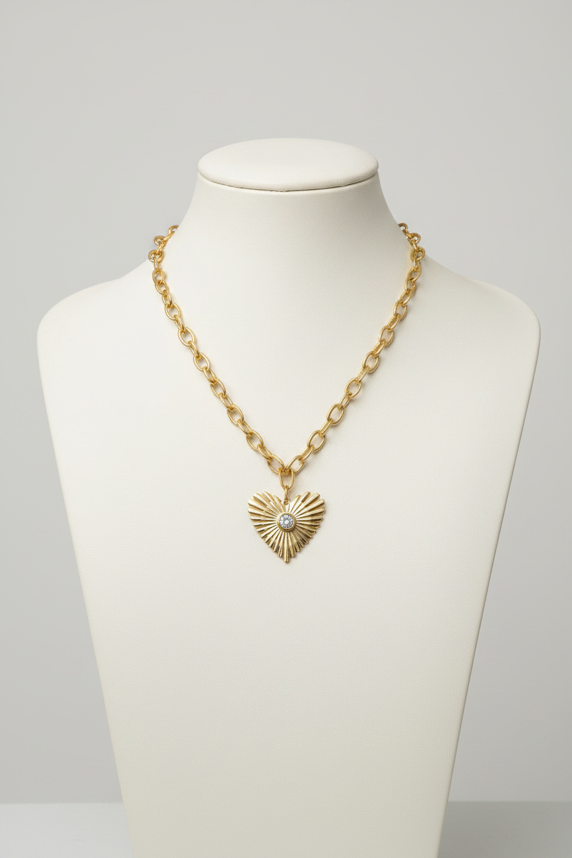Gold necklace with heart pendant and measurement details on a white background