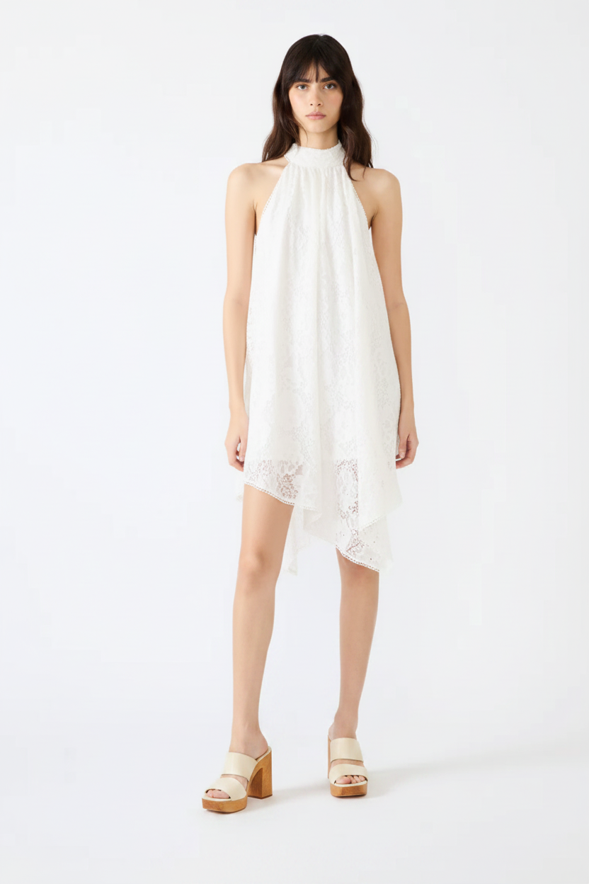 Woman wearing a white dress with black boots on a white background