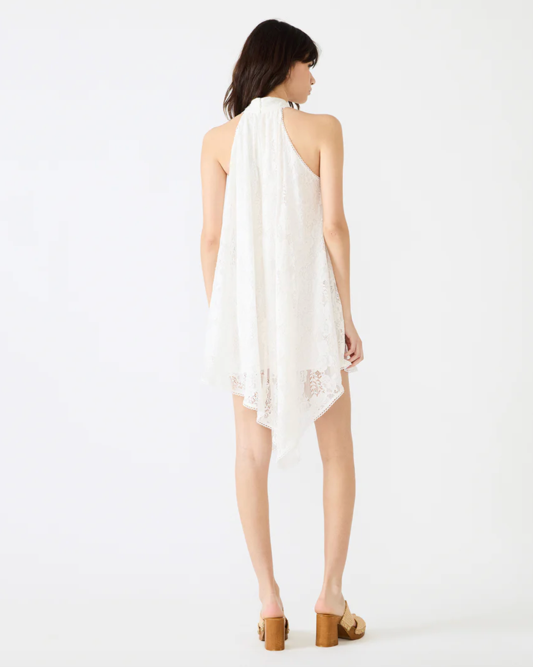 Woman wearing a white one-shoulder dress on a white background