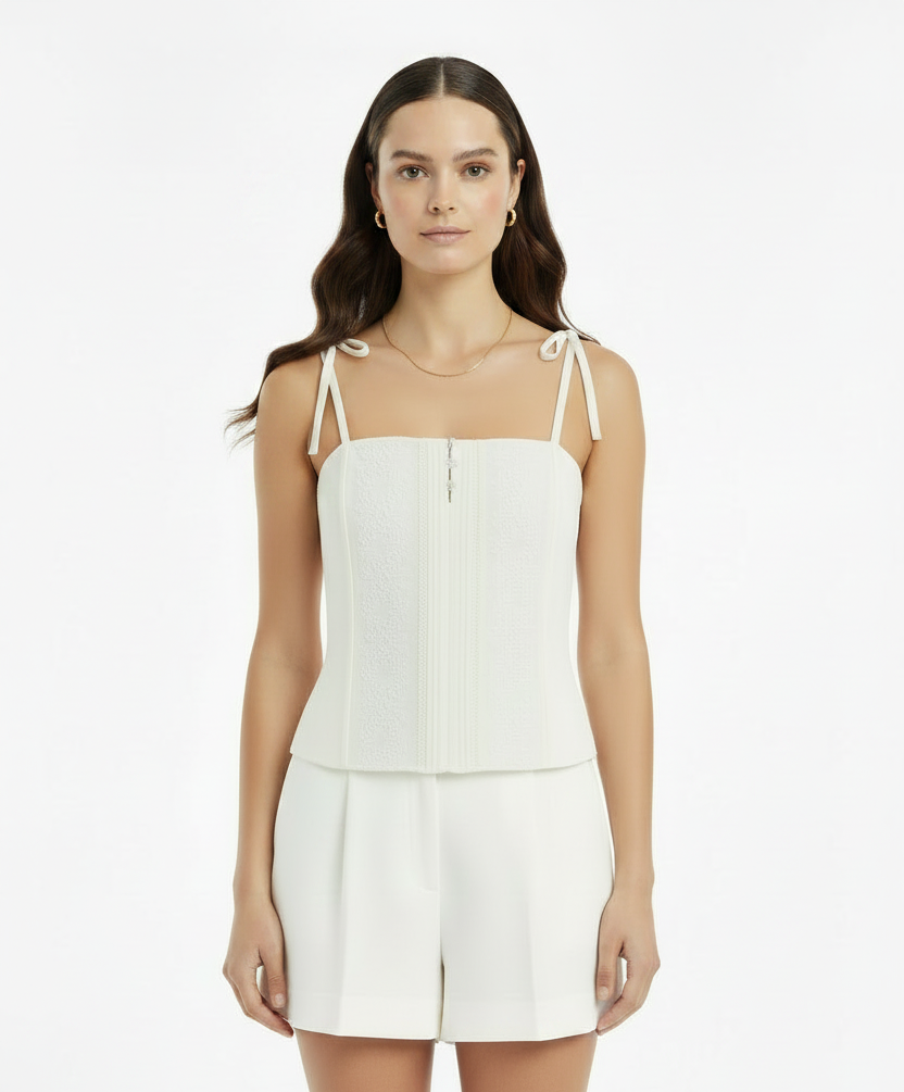 White lace top with thin straps on a white background
