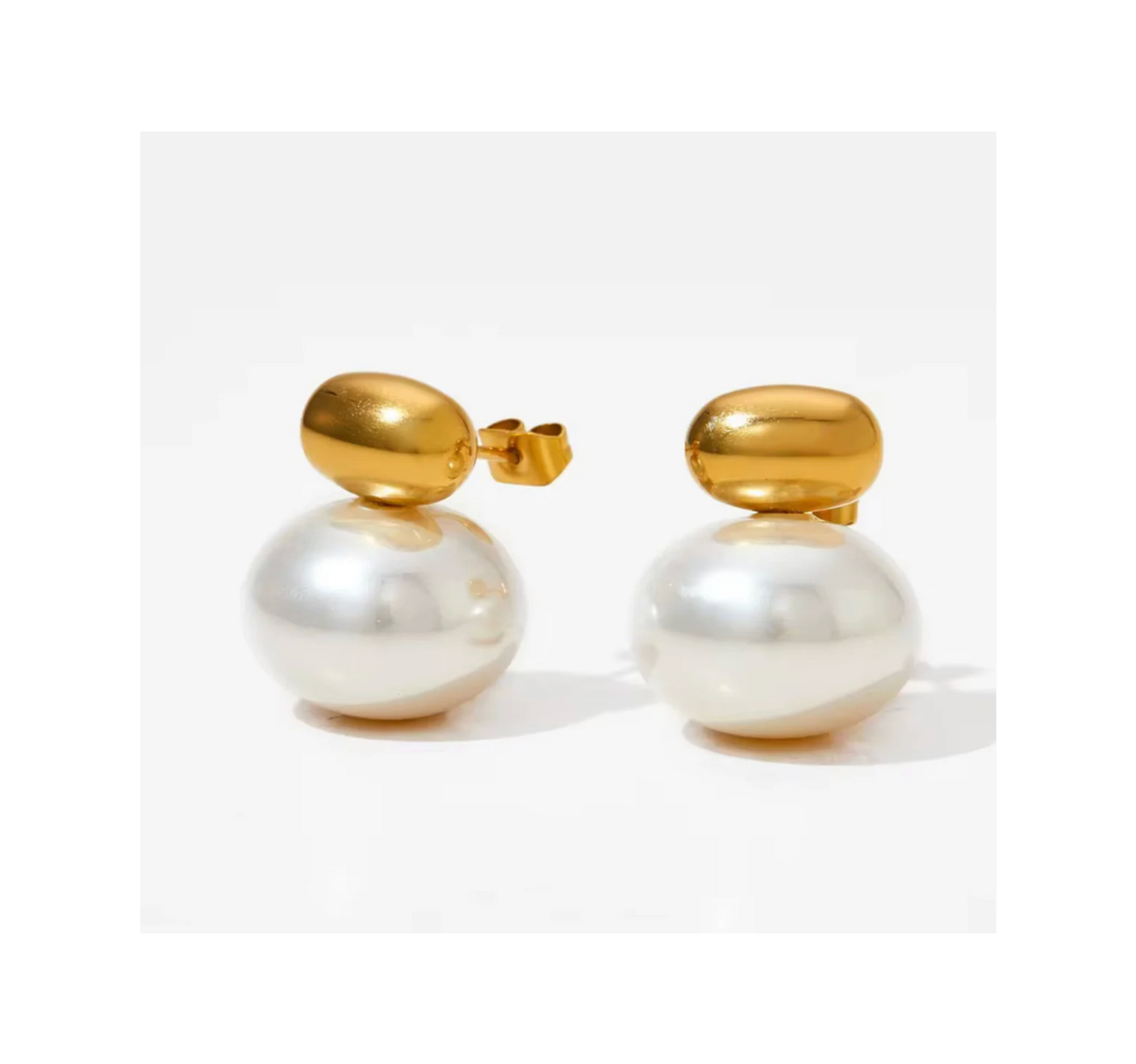 Gold and pearl earrings on a white background